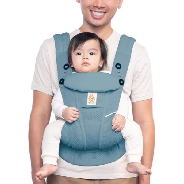 Ergobaby Omni Breeze All-In-One Baby Carrier in use, featuring breathable SoftFlex™ mesh fabric, adjustable straps, and a detachable storage pouch for parents and babies aged 0-4 years